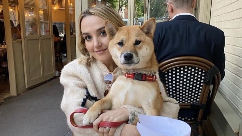 Chloe Fineman holding her dog, Peach