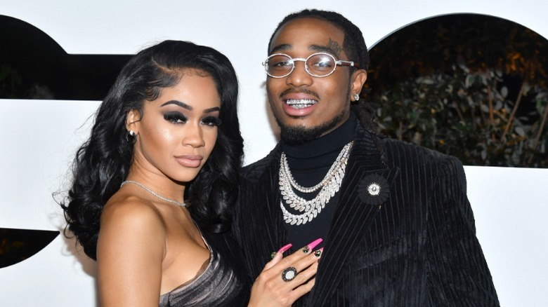 Saweetie hand on Quavo's chest