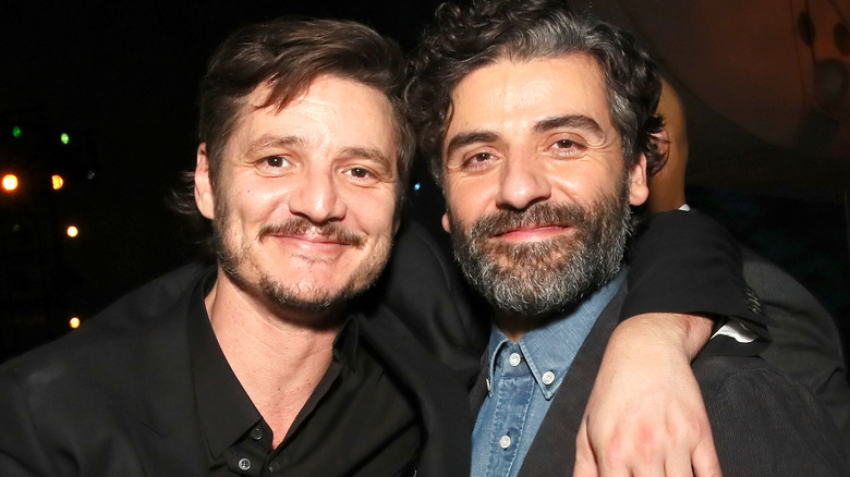 Pedro Pascal and Oscar Isaac both smiling