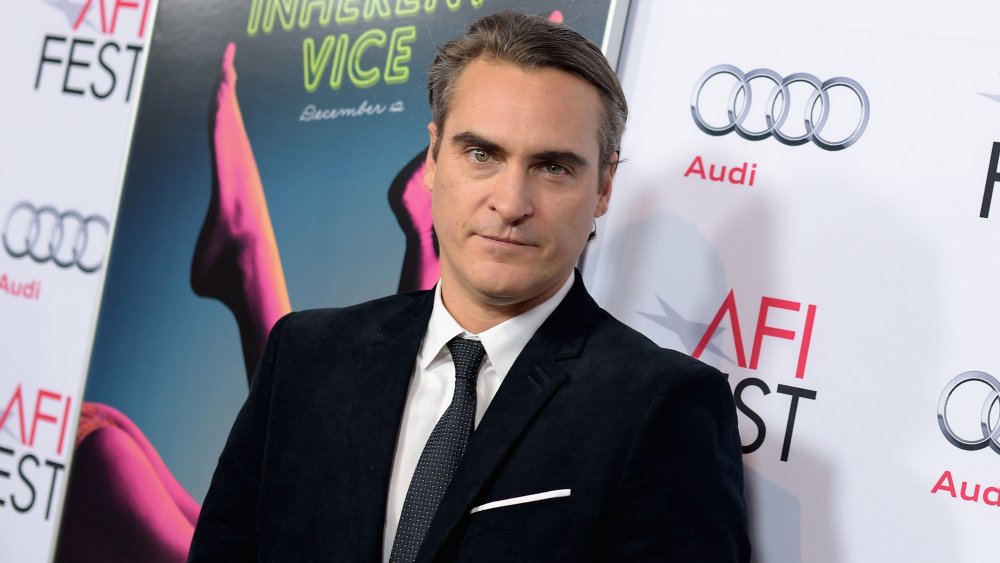 A cleaned-up Joaquin Phoenix in a black velvet suit at a movie premiere in 2014