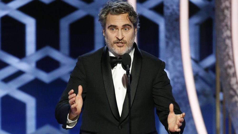 Joaquin Phoenix speaking while gesturing with his hands at the 2020 Golden Globes