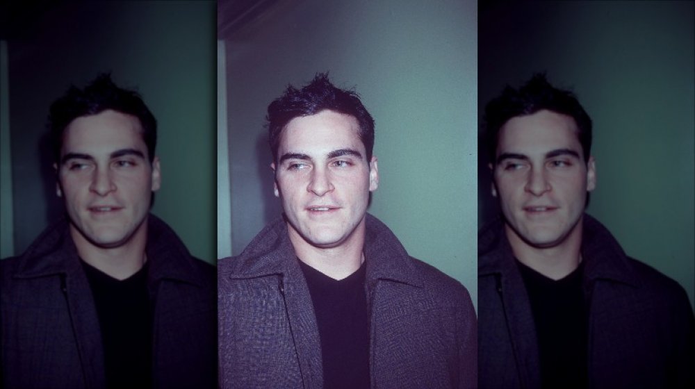 Joaquin Phoenix in a grey pea coat at a movie premiere in 2001