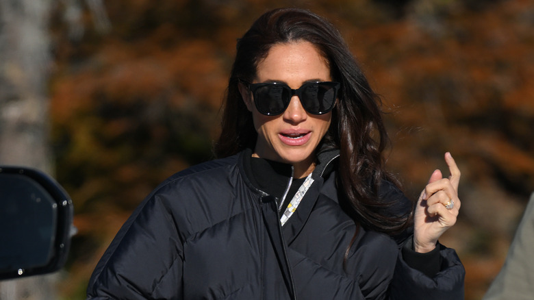 Meghan Markle walking with sunglasses on