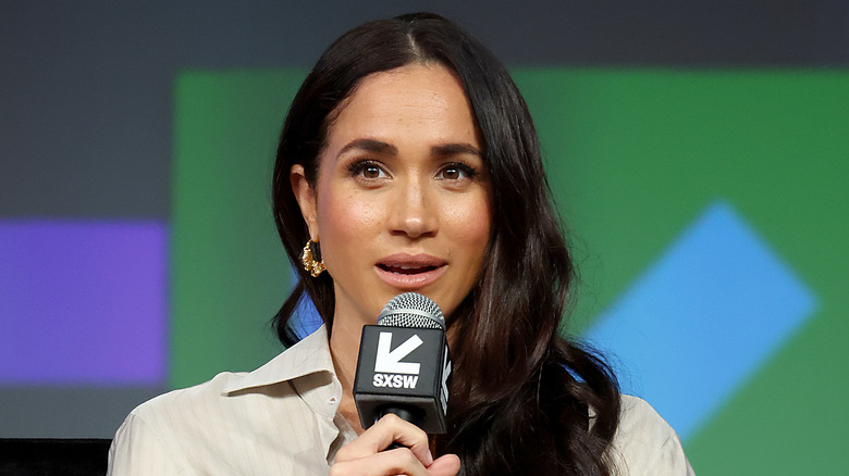 Meghan Markle speaking into a microphone