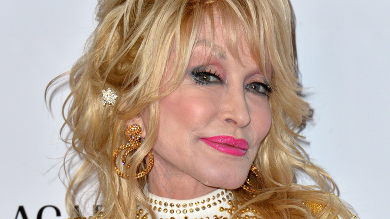 Dolly Parton smiling with pink lip