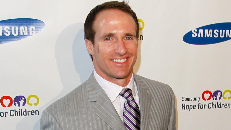 Drew Brees posing in a suit