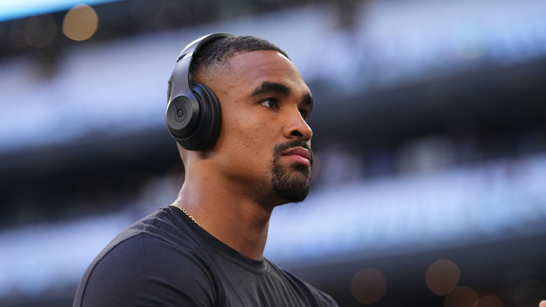 Jalen Hurts wearing headphones, looking away