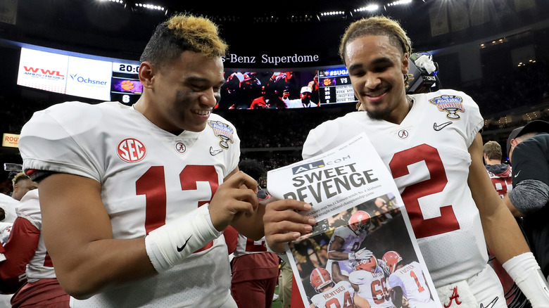 Jalen Hurts and Tua Tagovailoa hold newspaper