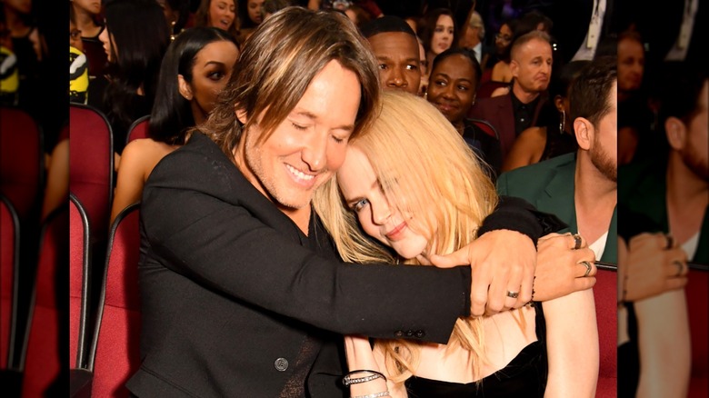 Nicole Kidman's head on Keith Urban's shoulder smiling