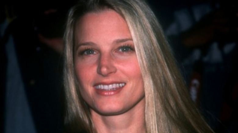 Bridget Fonda with straight blonde hair, smiling