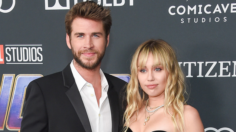 Miley Cyrus and Liam Hemsworth smiling