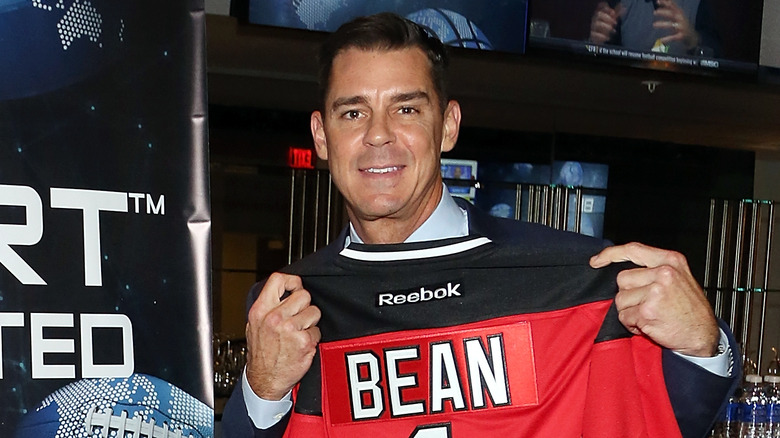 Billy Bean holding up a jersey with his name