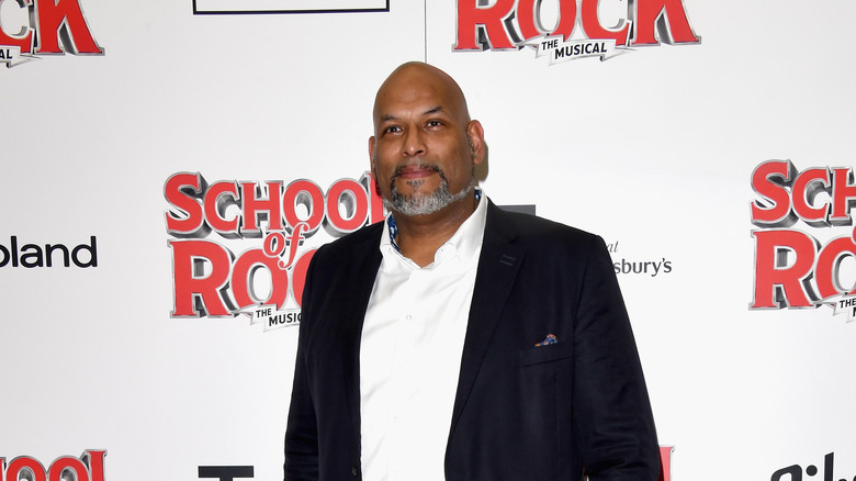 John Amaechi posing on a red carpet