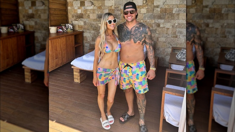 Christina and Josh Hall wearing matching swimsuits