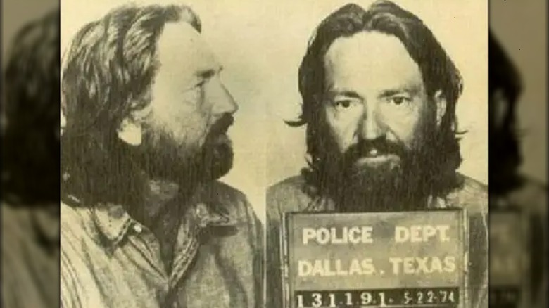 Willie Nelson posing for mugshot