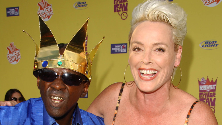 Brigitte Nielsen and Flava Flav posing at an event