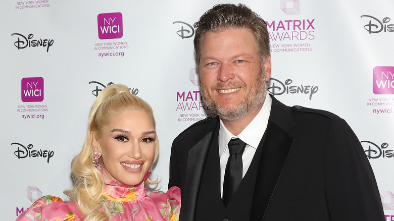 Gwen Stefani and Blake Shelton posing at an event