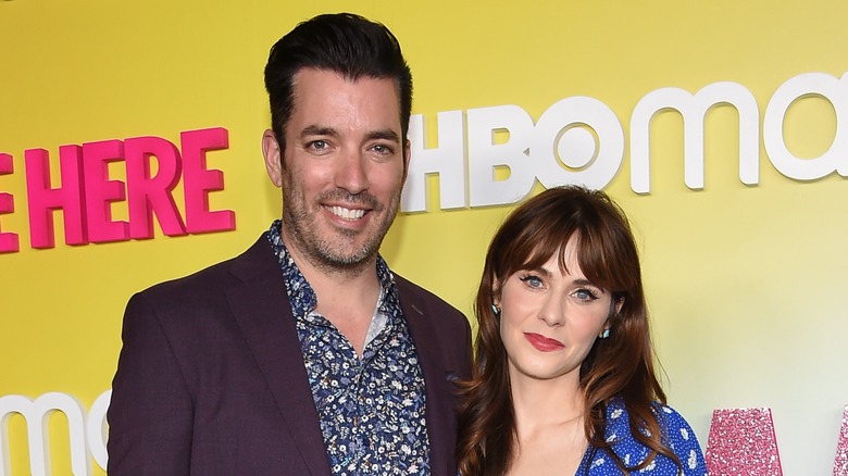 Jonathan Scott and Zooey Deschanel posing at an event