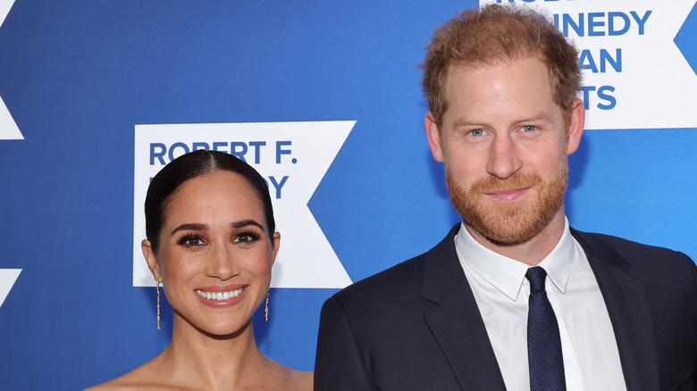 Meghan Markle and Prince Harry posing at an event