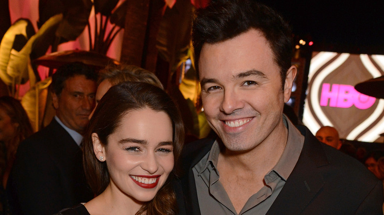 Emilia Clarke and Seth MacFarlane smiling at a party