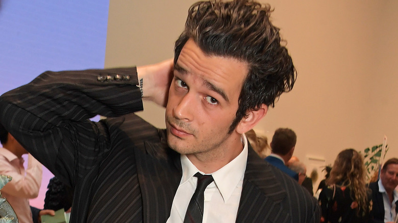 Matt Healy with his arm behind his head