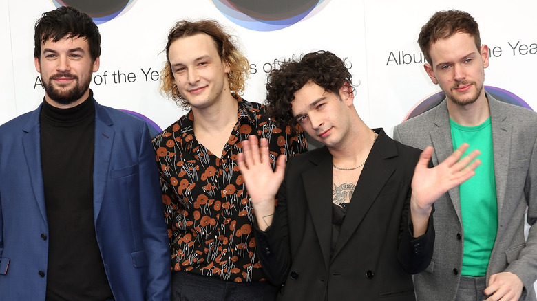 Matt Healy and The 1975 posing