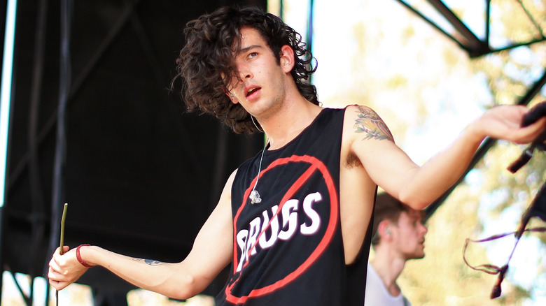 Matt Healy with his arms out