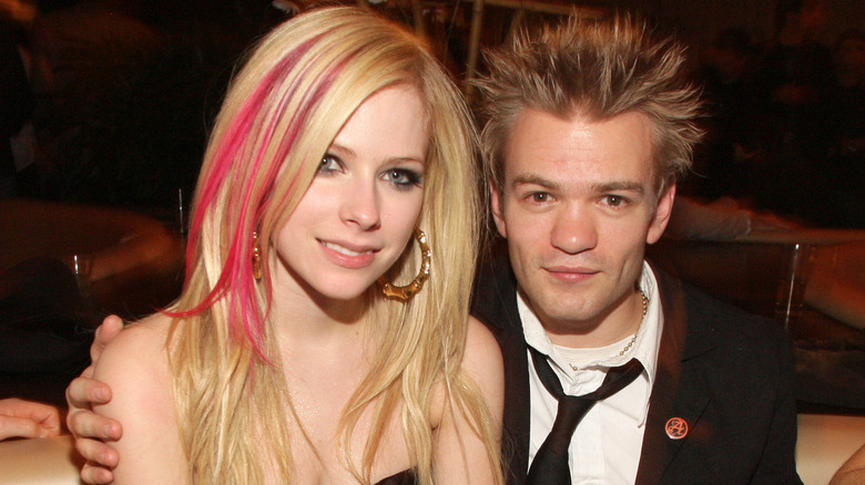 Avril Lavigne and Deryck Whibley sitting in a booth