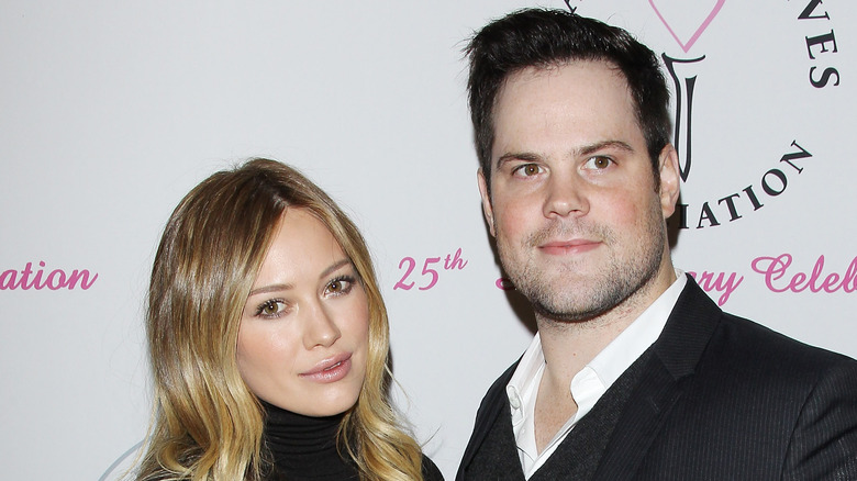 Hilary Duff and Mike Comrie posing at an event