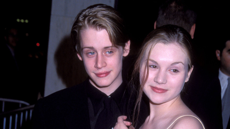 Macaulay Culkin and Rachel Miner posing at an event