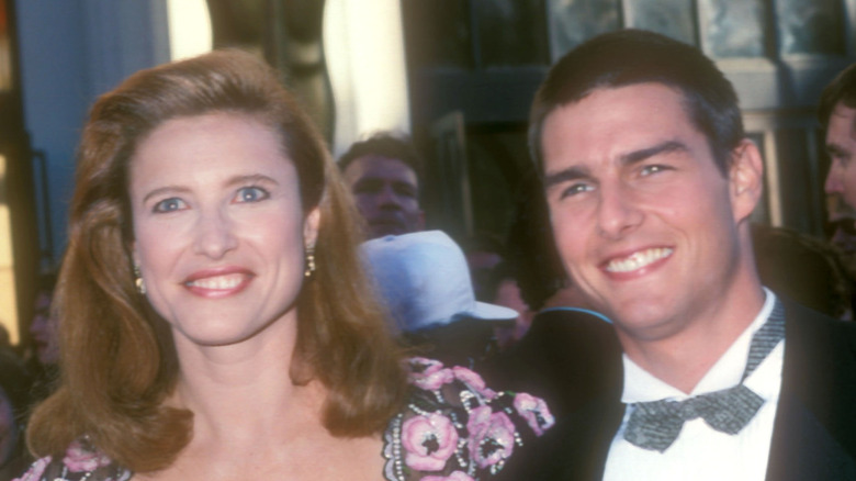 Mimi Rogers and Tom Cruise posing at an event