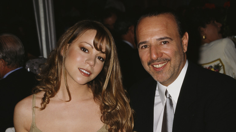 Mariah Carey and Tommy Mottola posing together at a table