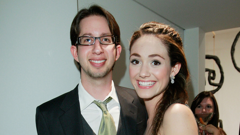 Justin Siegel and Emmy Rossum smiling at a party