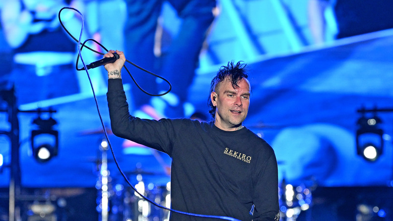 Bert McCracken on stage, holding microphone