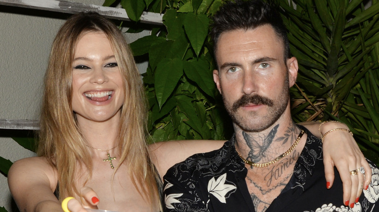 Behati Prinsloo and Adam Levine posing