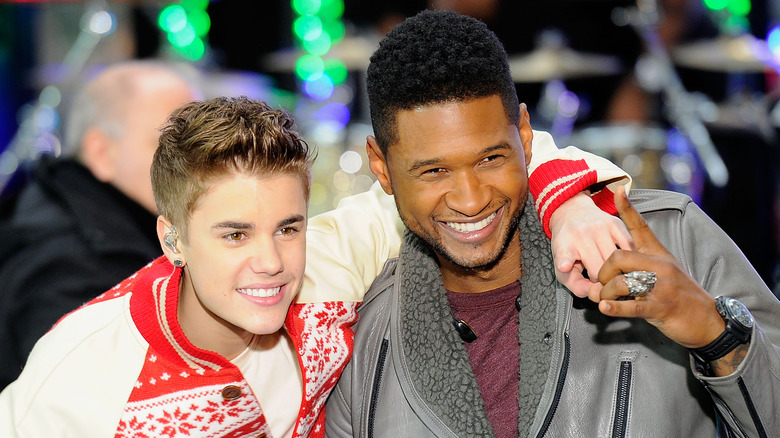 Justin Bieber arm around Usher