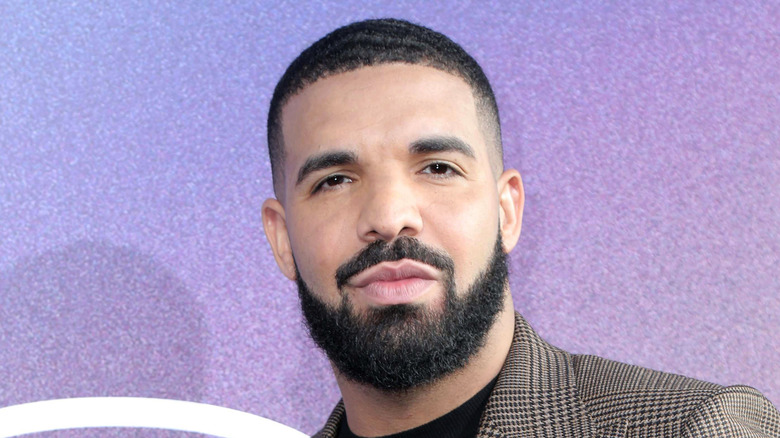 Drake posing at an event