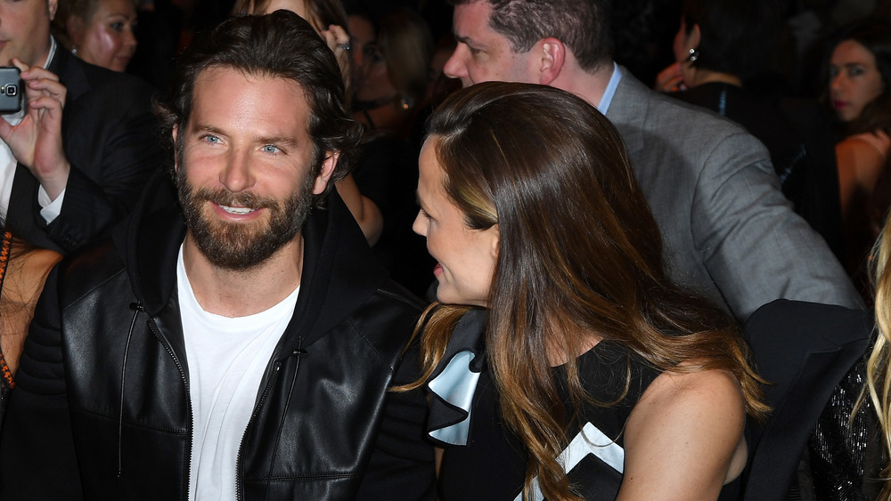 Bradley Cooper sitting with Jennifer Garner