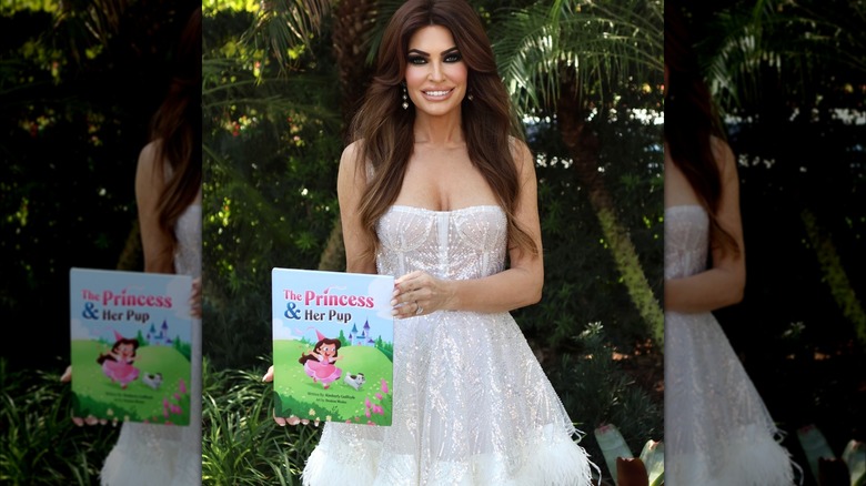 Kimberly Guilfoyle holding her book