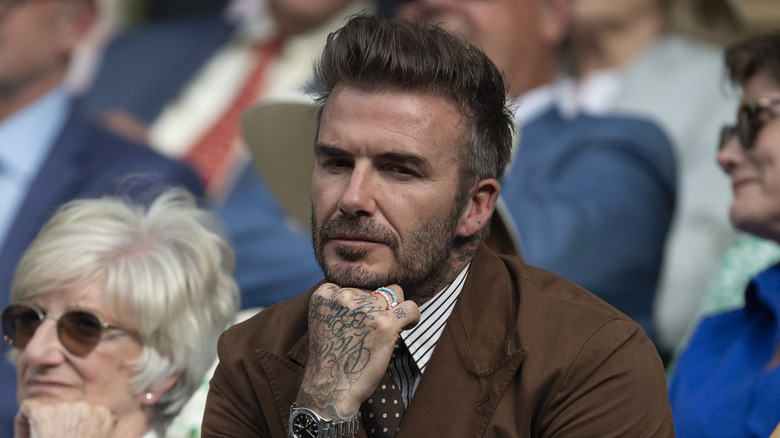 David Beckham with his hand on his chin