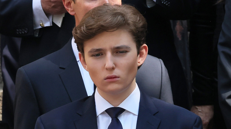 Barron Trump black suit scowling