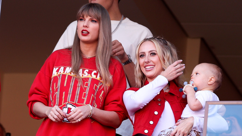 Taylor Swift frowning, Brittany Mahomes smiling