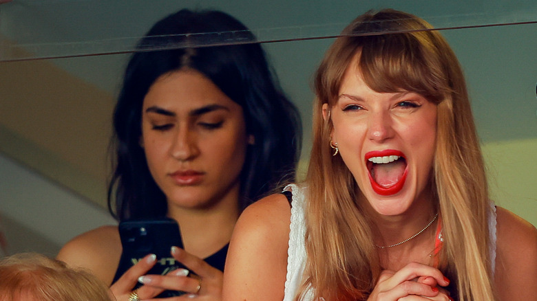 Pia Malihi looking at phone, Taylor Swift cheering