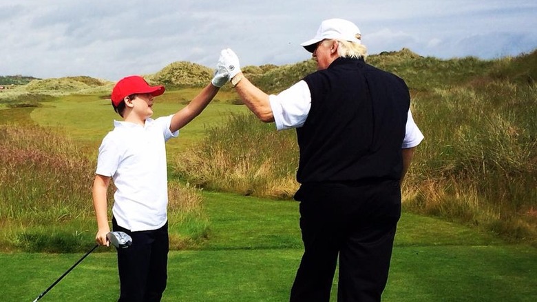 Donald Trump, Barron Trump clasping hands