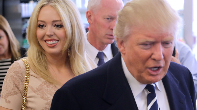 Tiffany smiling behind Donald Trump