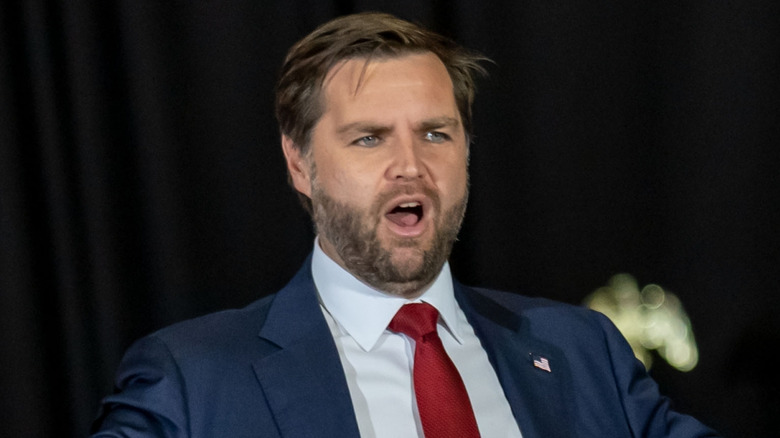 JD Vance wearing a suit with his mouth open