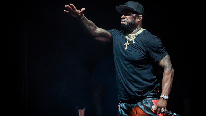 50 Cent holding hand out mid-performance