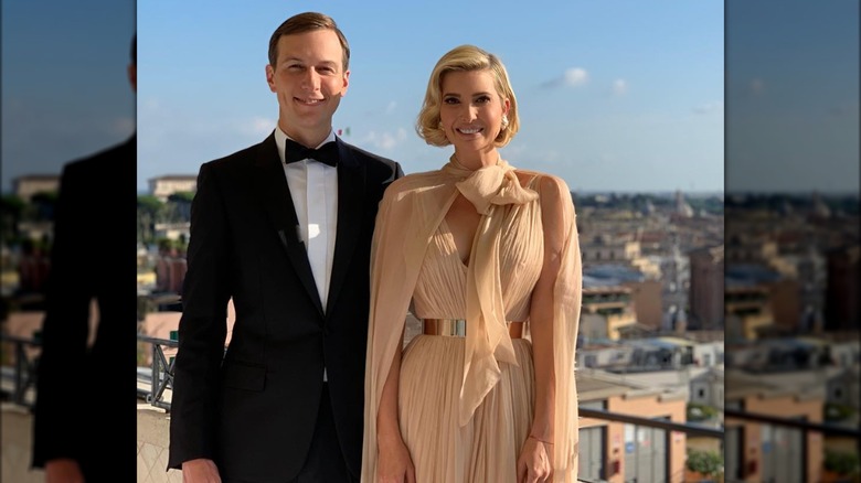 Ivanka Trump Jared Kushner posing outdoors on a balcony