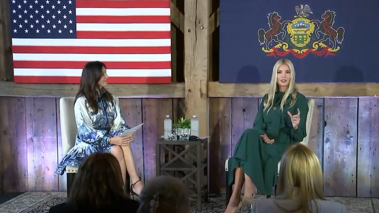 Ivanka Trump seated and speaking onstage in a green dress