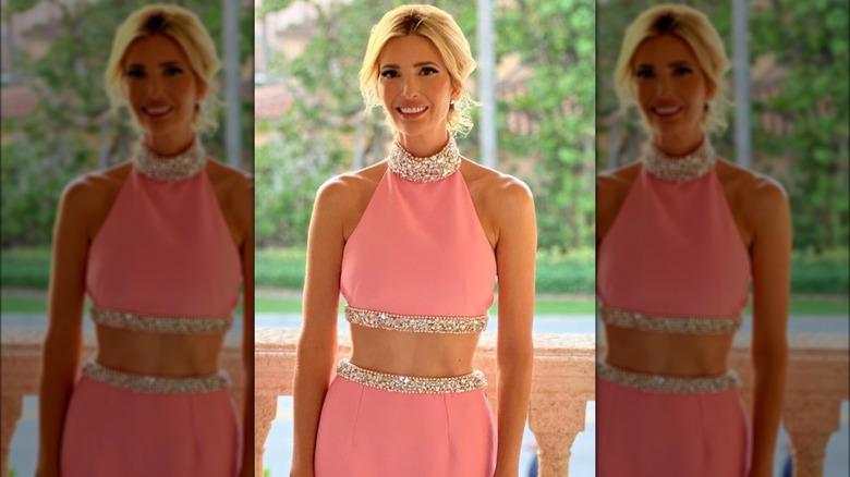 Ivanka Trump smiling outdoors in a pink top and matching skirt